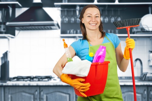 Supervisor discussing safe cleaning procedures with a cleaner